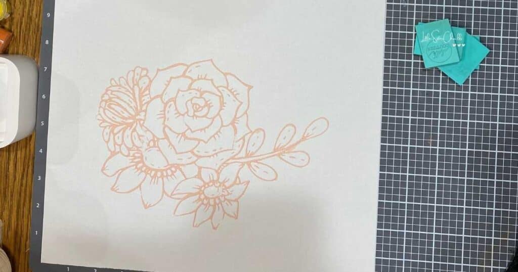 Outline of flowers on a white background with several squeegees next to it for blog post Try Your Hand at Watercoloring with Chalk Couture