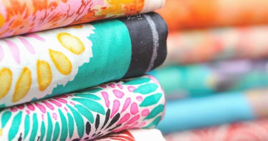 Folded stack of fabrics for blog post 10 Tips for Finding Inspiration for Your Chalk Couture Projects