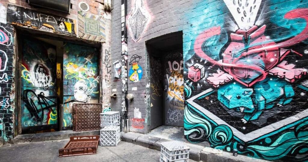 Graffiti on walls of buildings on an urban street for blog post 10 Tips for Finding Inspiration for Your Chalk Couture Projects