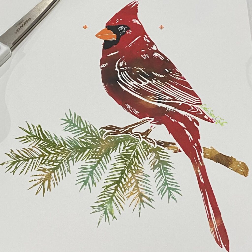 A cardinal chalked on ChalkSuede Paper using the marbling technique for the blog post "DIY Scrap Wood Projects".