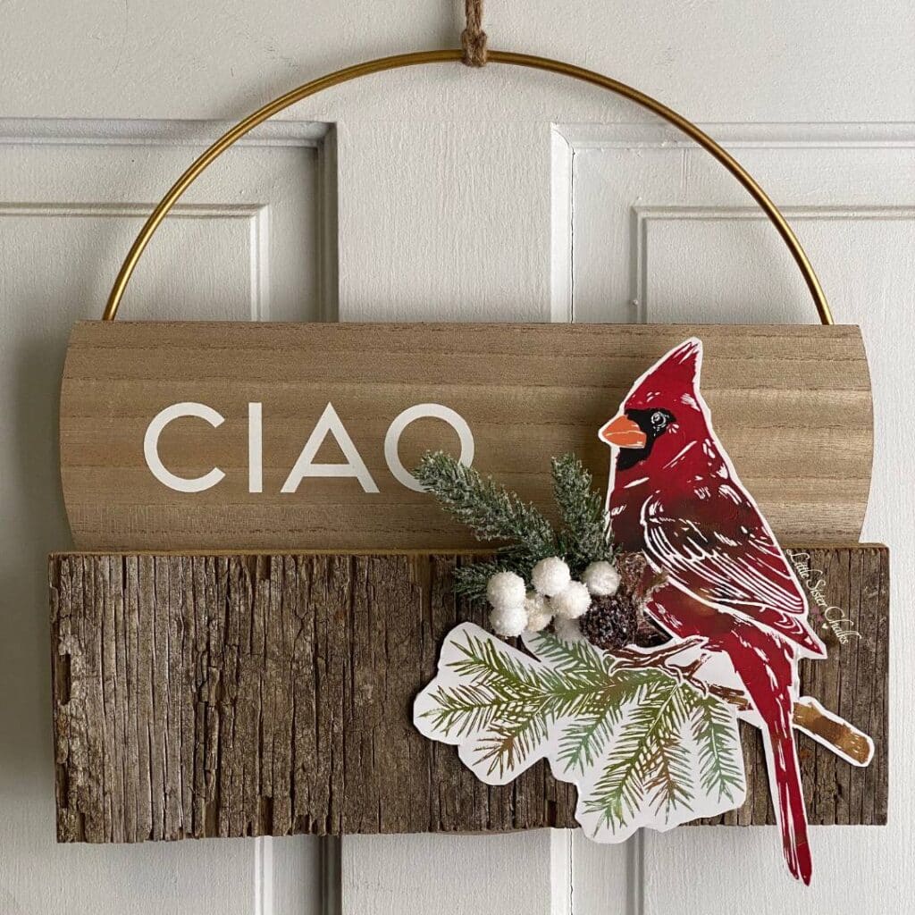 A hoop wreath on a door made with the Chalk Couture Hoop Wreath, a piece of scrap wood, a cardinal chalked on ChalkSuede Paper and some embellishments for the blog post "DIY Scrap Wood Projects".