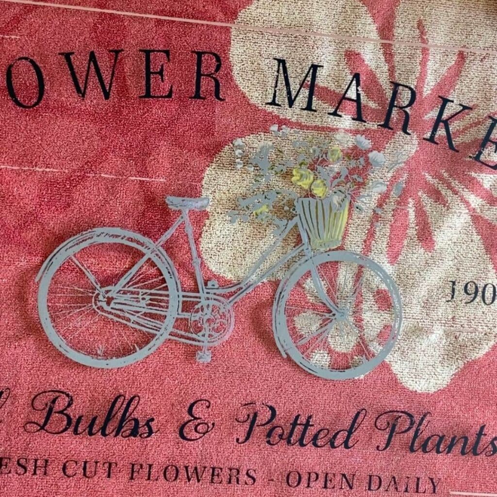 A close up of the bicycle chalked in grey chalk paste from the Chalk Couture Flower Market stencil for the blog post "An Old Window Gets New Life with Chalk Couture".