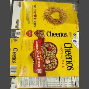 A flattened Cheerios box on a craft mat for the blog post "Two Simple Ways to Reuse Cardboard Boxes Around Your Home".