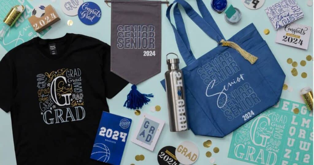 A variety of graduation related merchandise like a t-shirt with "grad" in different fonts and colors, a grey banner and a blue tote bag with "Senior 2024", and a water bottle with "24 Grad" for the blog post "Create One of a Kind Party Decorations with Chalk Couture".