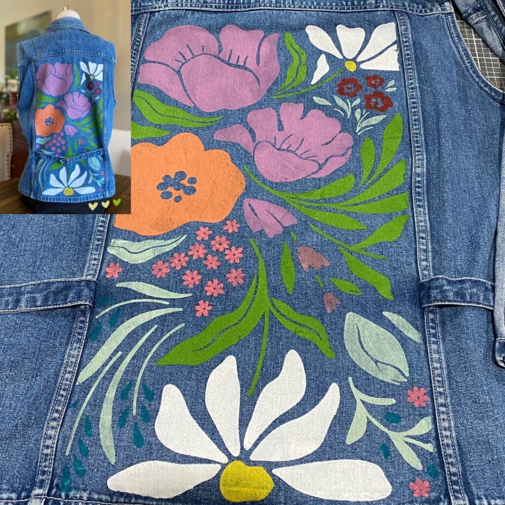 A close-up of the back of a denim vest stenciled in a boho floral pattern in various ink colors including green, white, purple, orange and yellow with an inset of the vest on a mannequin for the blog post "Stencil & Stitch Your Style: Upcycled Outerwear Edition".