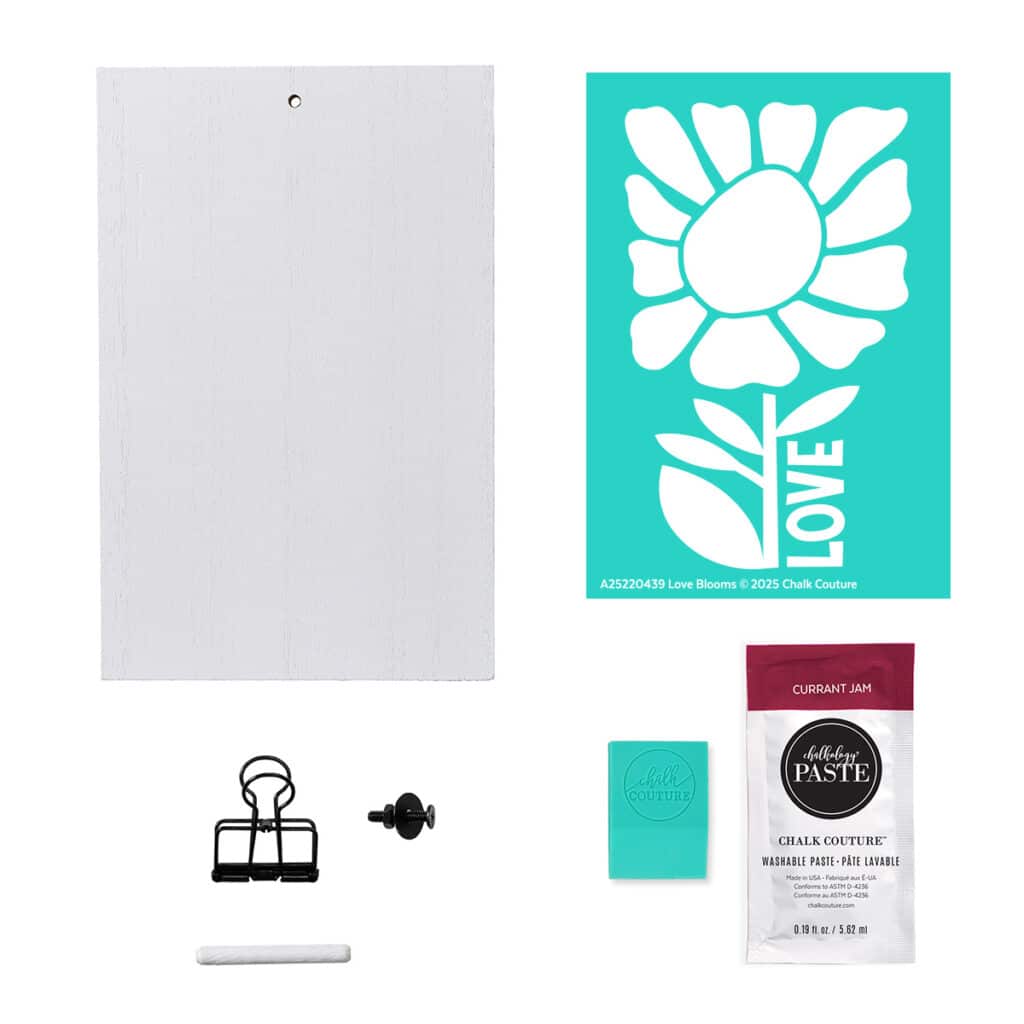 A photo of the contents of the Chalk Couture Love Blooms Try Me Kit including a white clipboard stand, the Love Blooms stencil, a packet of Currant Jam Chalkology Paste, and a squeegee for the blog post "Try your hand at chalking with a Chalk Couture Try-me Kit".